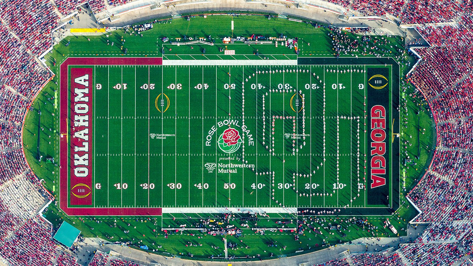 The Oklahoma University band cheers proudly in their cardinal and cream regalia, forming the letters 'OU' on the field of the iconic Rose Bowl Stadium and showcasing their enthusiasm for the Sooners during the historic 2018 Rose Bowl Game