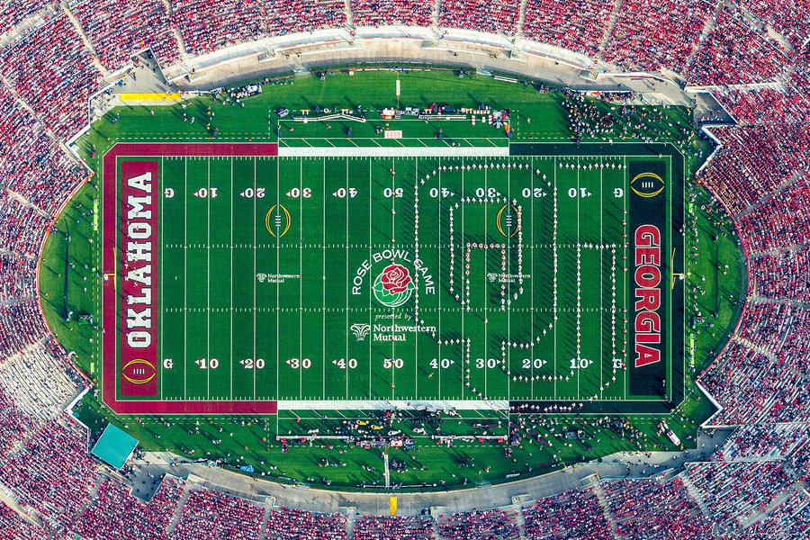 The Oklahoma University band cheers proudly in their cardinal and cream regalia, forming the letters 'OU' on the field of the iconic Rose Bowl Stadium and showcasing their enthusiasm for the Sooners during the historic 2018 Rose Bowl Game