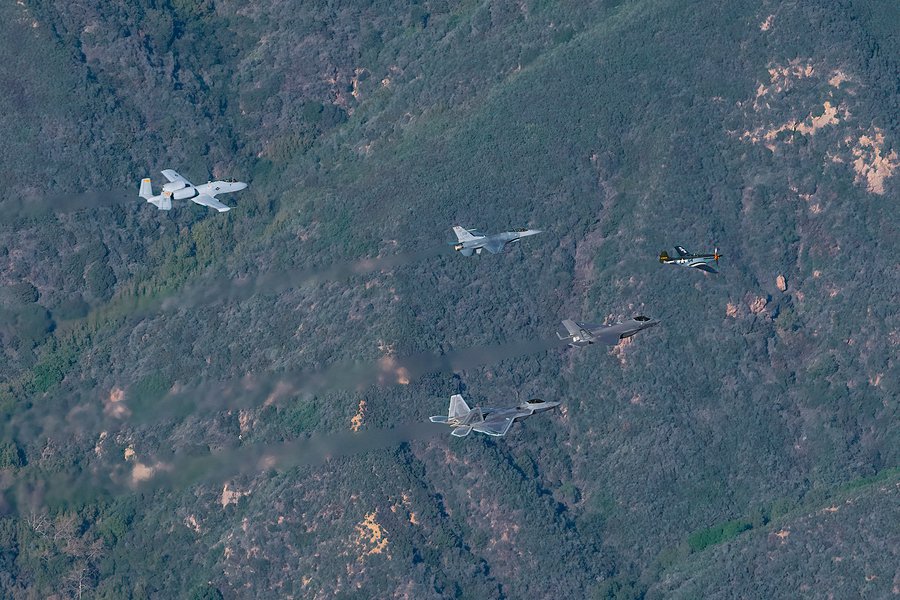 Blog image of an F-22, F-35, P-51, F-16 and A-10 flying along the Santa Monica Mountains, in preparation for their Super Bowl LVI flyover