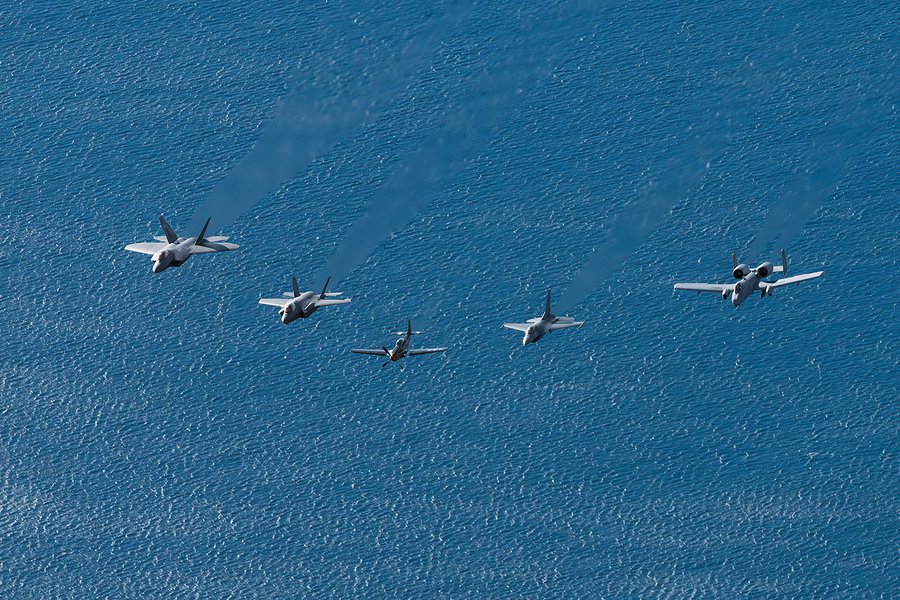 Blog photo of the US Air Force Heritage Flight, which includes an F-22, F-35, P-51, F-16 and A-10 flying in formation over the ocean off Malibu, California