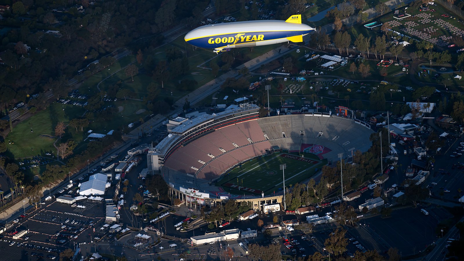 Blog photo of the Goodyear Blimp flying over the Rose Bowl Stadium in the early morning on New Years Day 2022
