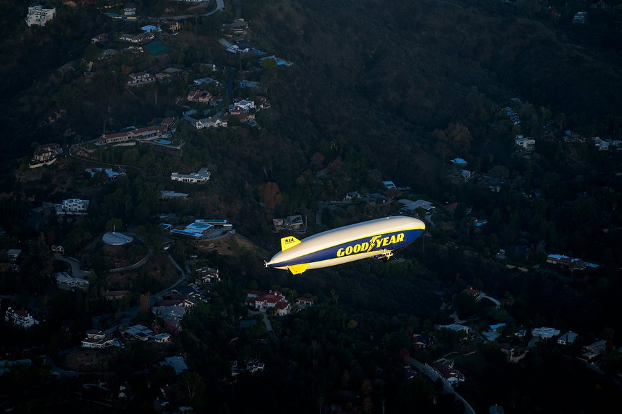 Blog photograph of the Goodyear Blimp flying over a residential neighborhood on January 1st 2022