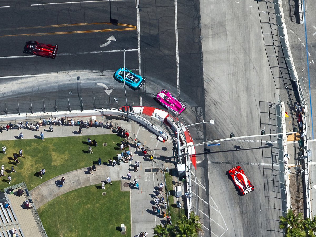 Spectators watch on as race cars whiz by during the Acura Grand Prix of Long Beach, an annual motor racing event held in downtown Long Beach, California.