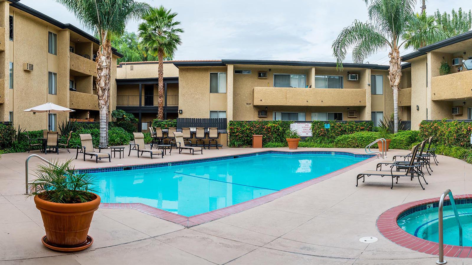 Exterior architectural image of the pool and common areas of an apartment complex in Canoga Park, California