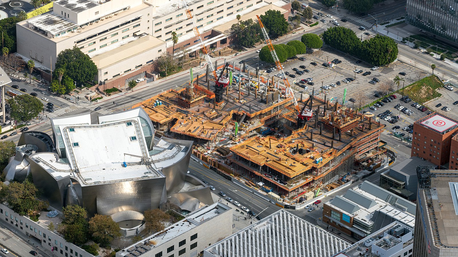 Blog aerial image of the framing phase of The Grand, with the Walt Disney Concert Hall in the foreground and the Stanley Mosk Courthouse in the background