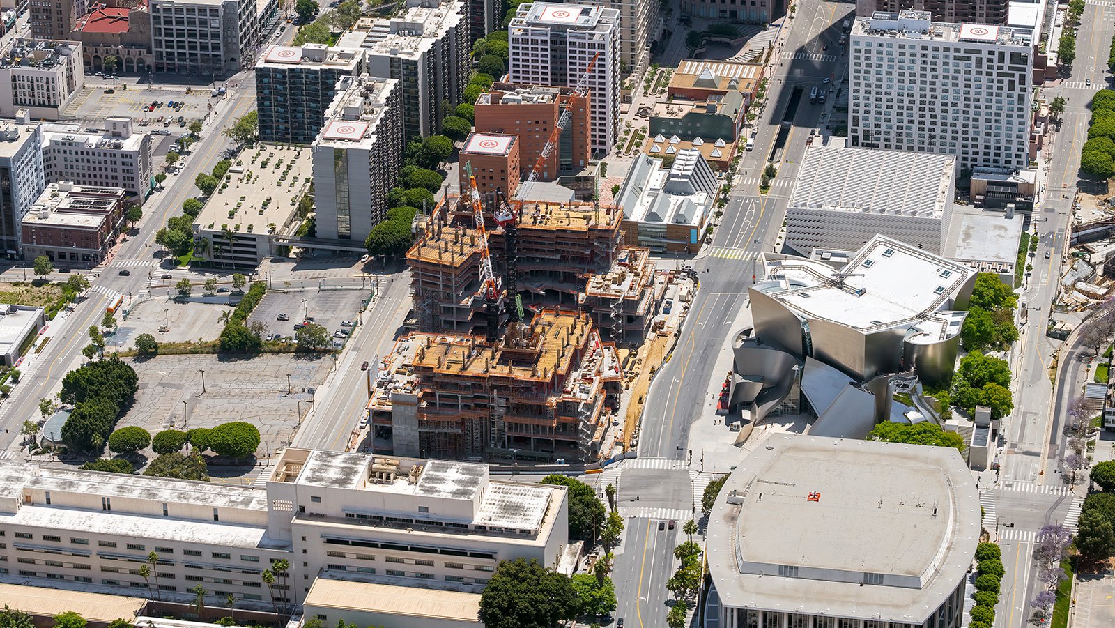 Aerial construction photo showing the construction progress of The Grand, with the Dorothy Chandler Pavilion, Stanley Mosk Courthouse, Walt Disney Concert Hall and The Broad also visible.