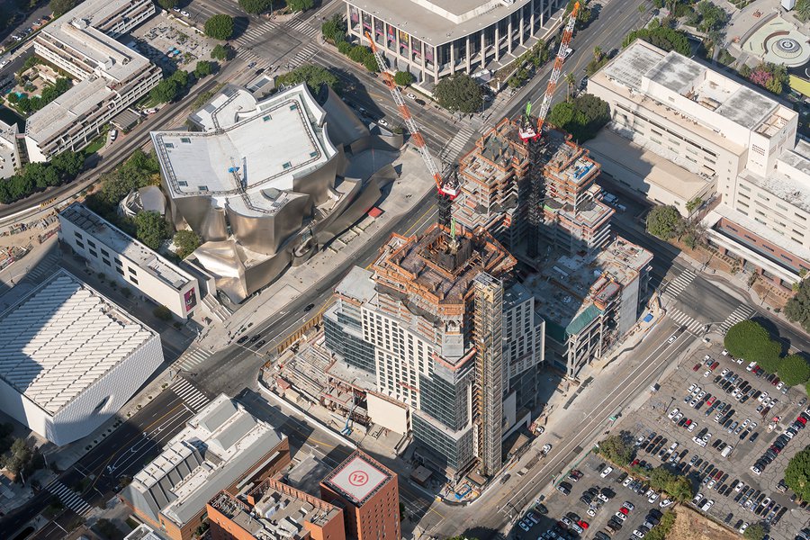 Aerial blog photo of two tall cranes climbing higher and higher and more and more floors are completed during construction of The Grand in Downtown Los Angeles, California