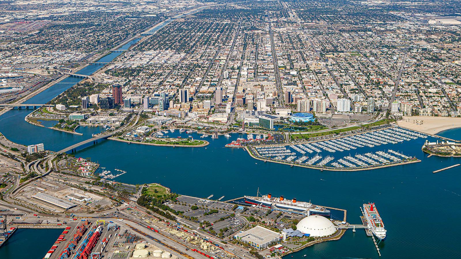 Aerial cityscape of Downtown Long Beach with the Queen Mary in the foreground