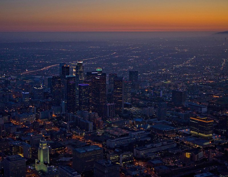 Aerial cityscape of the Downtown Los Angeles Skyline at night, just as the sun goes down