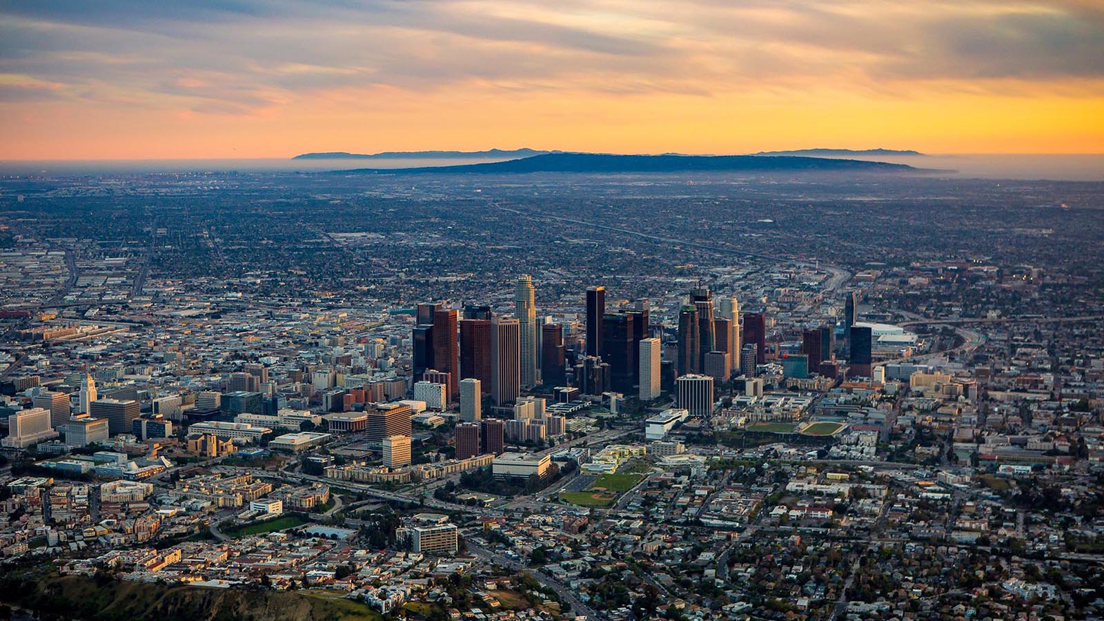 Aerial cityscape of Downtown Los Angeles Skyline at Sunset with Santa Catalina Island in the background