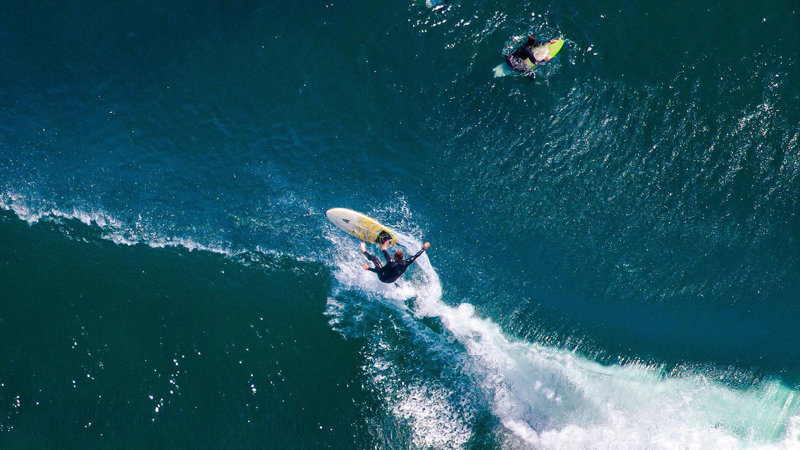 Sports photo of a Malibu surfer wipeout just off the California coast