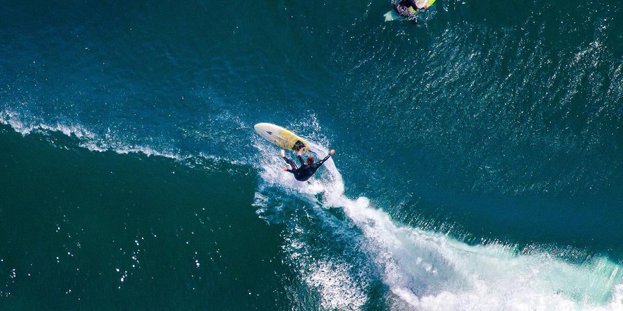 Sports photo of a Malibu surfer wipeout just off the California coast