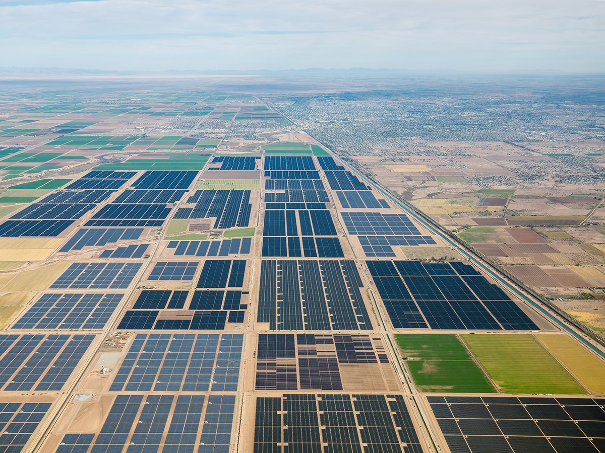 A sea of solar panels spanning across the stunning Imperial Valley desert landscape - a glimpse into the future of sustainable energy production in California.