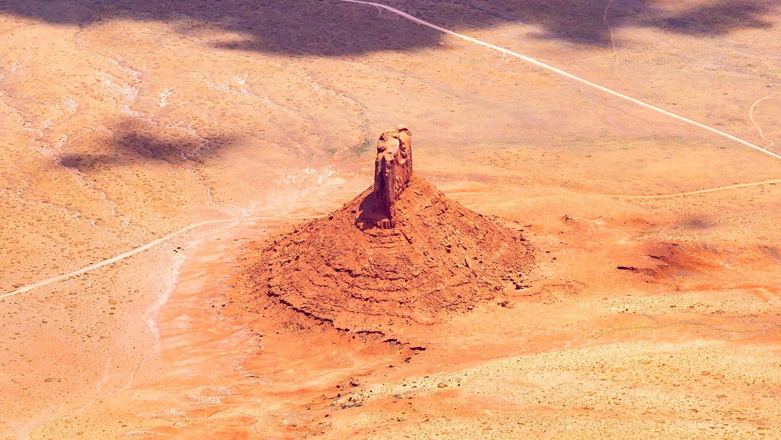 Blog image 1607 on a geologic formation rising from the ground in the Navajo Nation