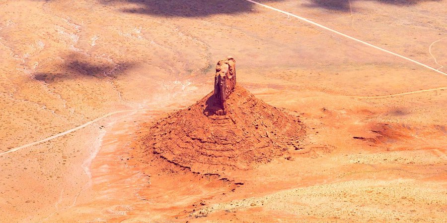 Blog image 1607 on a geologic formation rising from the ground in the Navajo Nation