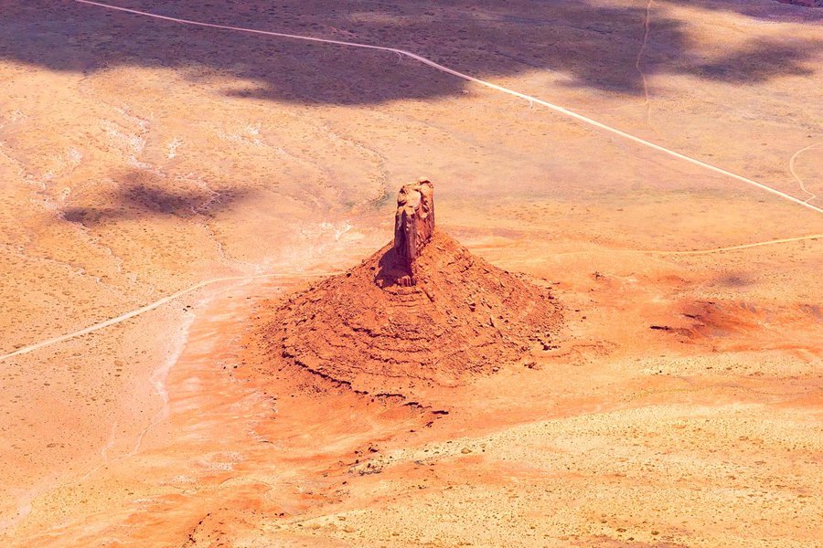 Blog image 1607 on a geologic formation rising from the ground in the Navajo Nation