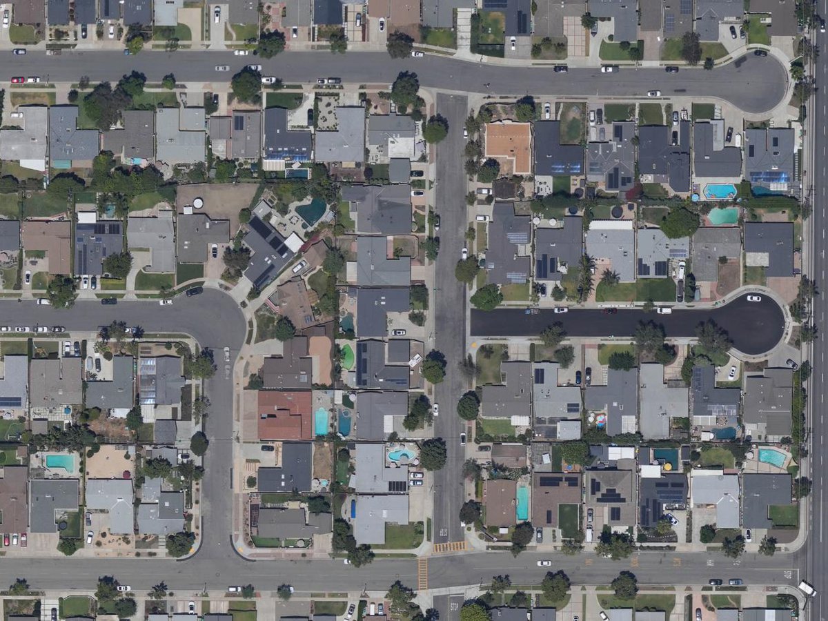 Orthophoto of a Southern California neighborhood with many blue swimming pools and a few green ones.