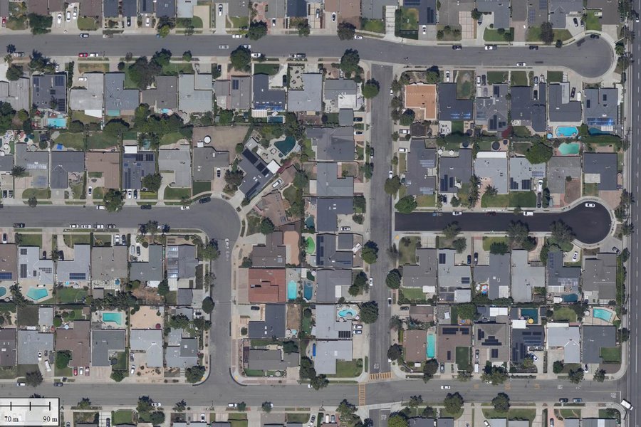 Orthophoto of a Southern California neighborhood with many blue swimming pools and a few green ones.