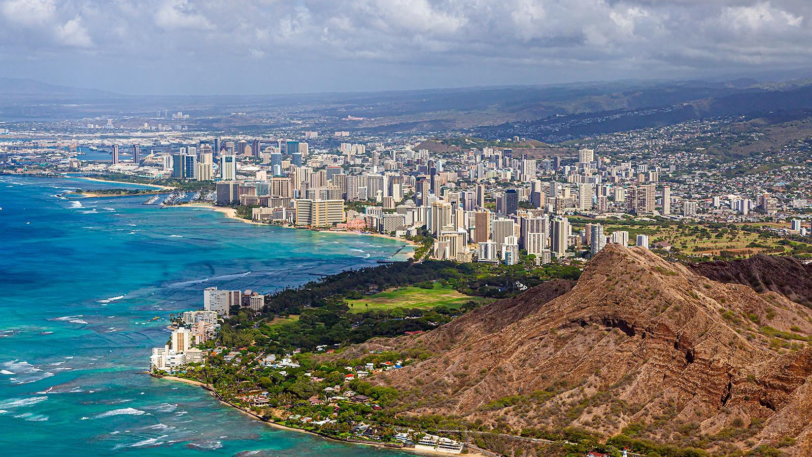 Aerial cityscape of Waikiki, Honolulu, on the Hawaiian Island of O'ahu with Diamondhead State Monument in the foreground