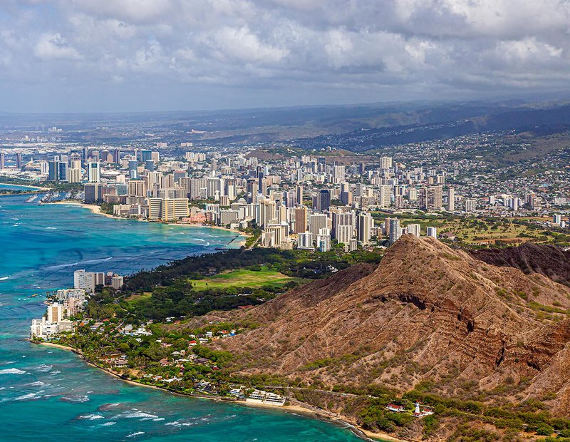 Aerial cityscape of Waikiki, Honolulu, on the Hawaiian Island of O'ahu with Diamondhead State Monument in the foreground