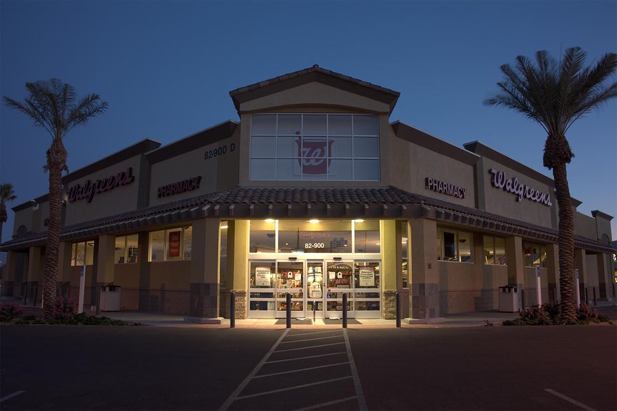 RAW exterior architectural photograph of a Walgreens store at sunrise