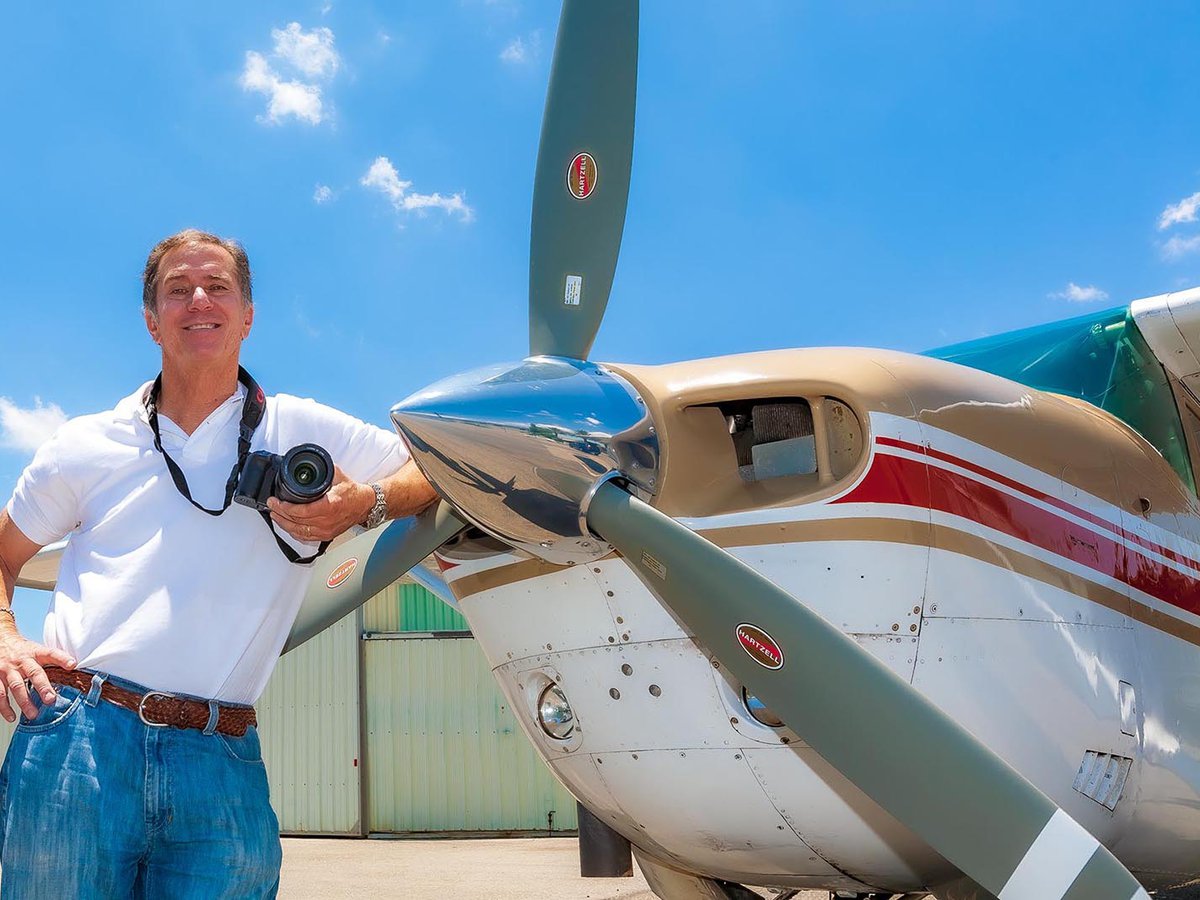 Services portrait of Mark Holtzman with his camera and airplane at Van Nuys Airport (KVNY)