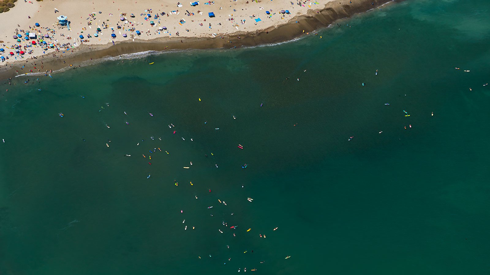 Blog image of beach goers and surfers in Dana Point, California on a hot summer day