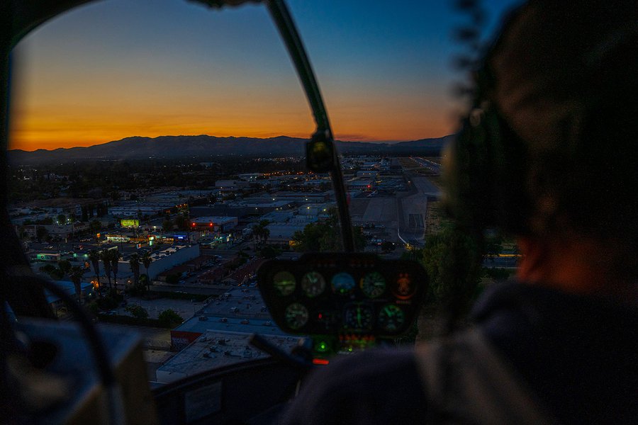 Blog image of cockpit view over Van Nuys, California, during sunset helicopter flight