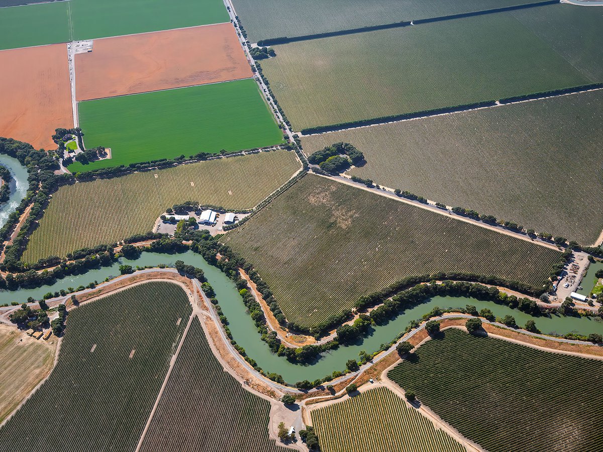 Blog image of a river flowing through an agricultural part of Sacramento, California