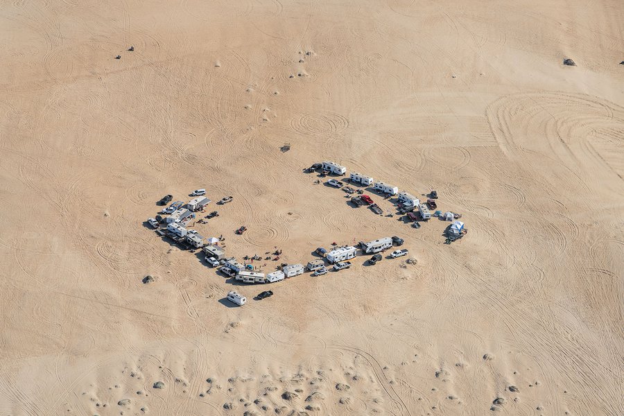 Blog photograph of many RVs make camp and prepare their off-road vehicles for a weekend on the Oceano Dunes near Pismo Beach, California