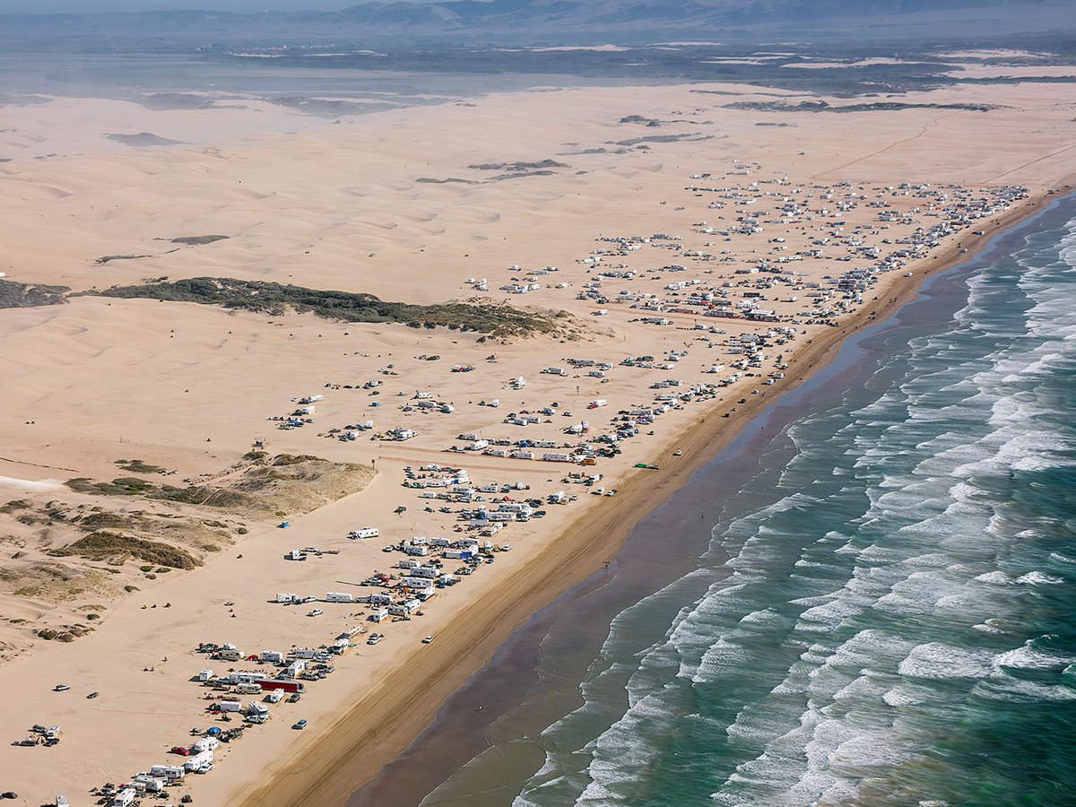 Aerial photo of RVs and off-road vehicles on the beach at Pismo Beach, California