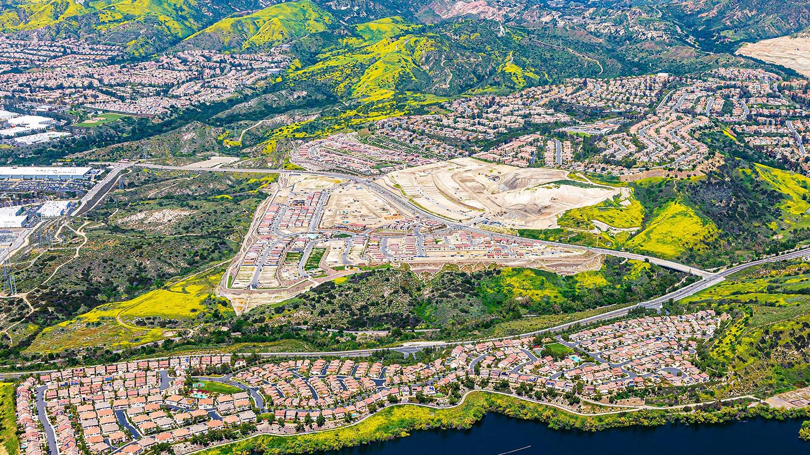 Construction image of the IronRidge housing community in Lake Forest with California poppies covering the nearby green spaces