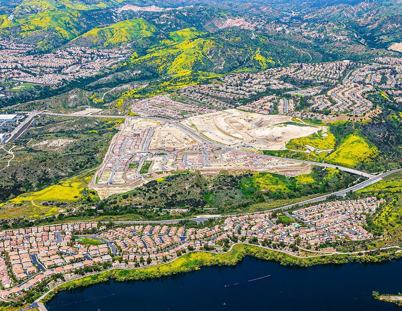 Construction image of the IronRidge housing community in Lake Forest with California poppies covering the nearby green spaces