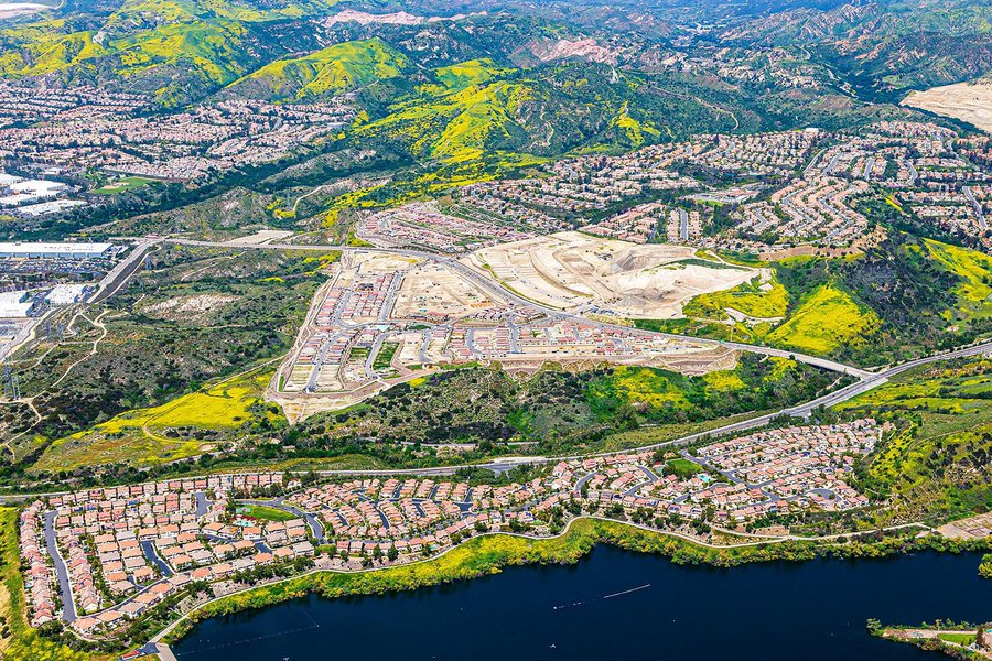 Construction image of the IronRidge housing community in Lake Forest with California poppies covering the nearby green spaces